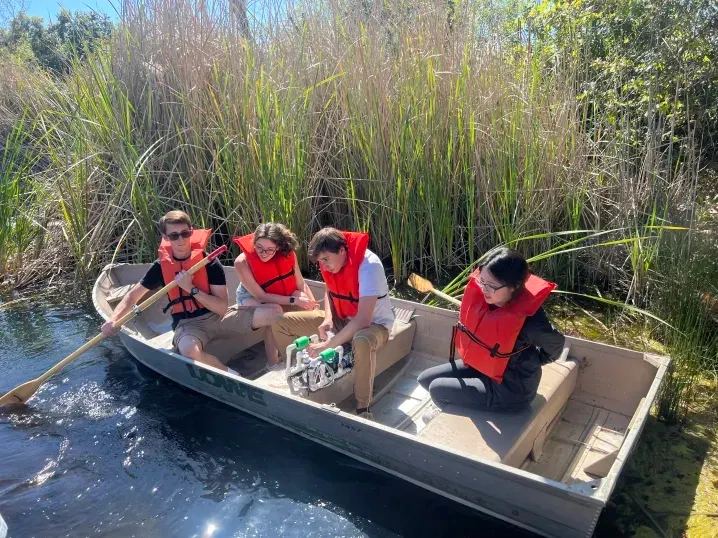Photo of Jacob and E80 Team traversing pHake Lake to collect test data.