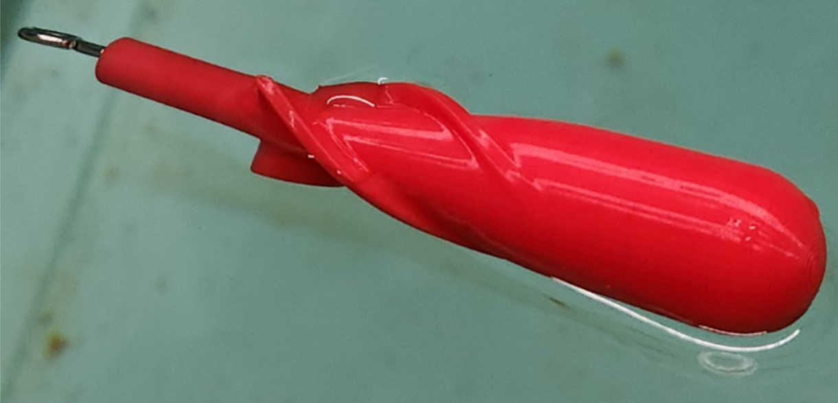 Photo of partially-submerged torpedo during buoyancy testing.