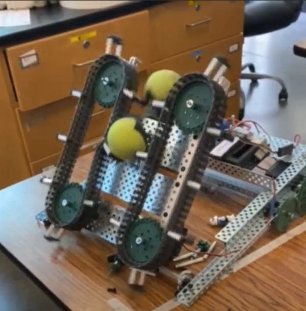 Photo of tennis ball retriever's dual conveyor belt subsystem being tested.