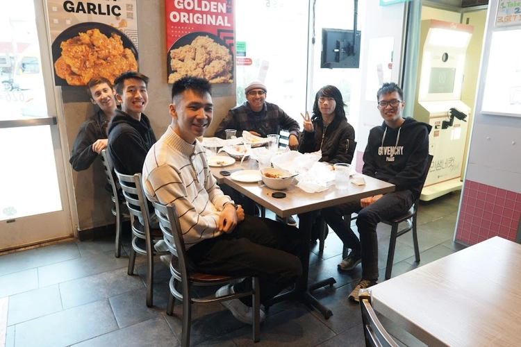 Photo of Jacob and other UPLIFT grads grabbing a meal.
