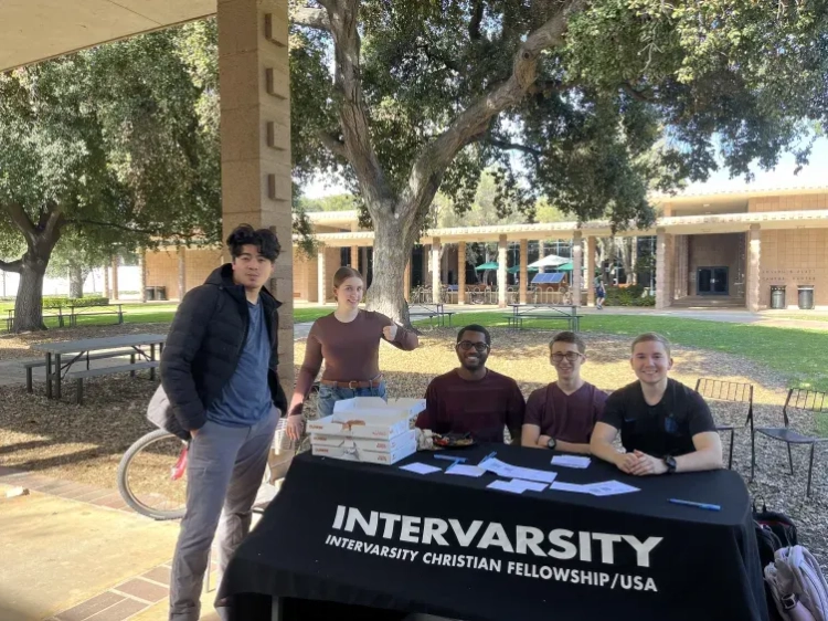 Photo of Jacob and other 5CIV members tabling outside a dining hall.