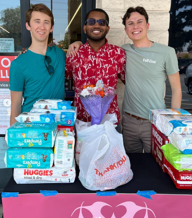 Photo of Jacob and other Cradling Love members collecting diapers and other donations.