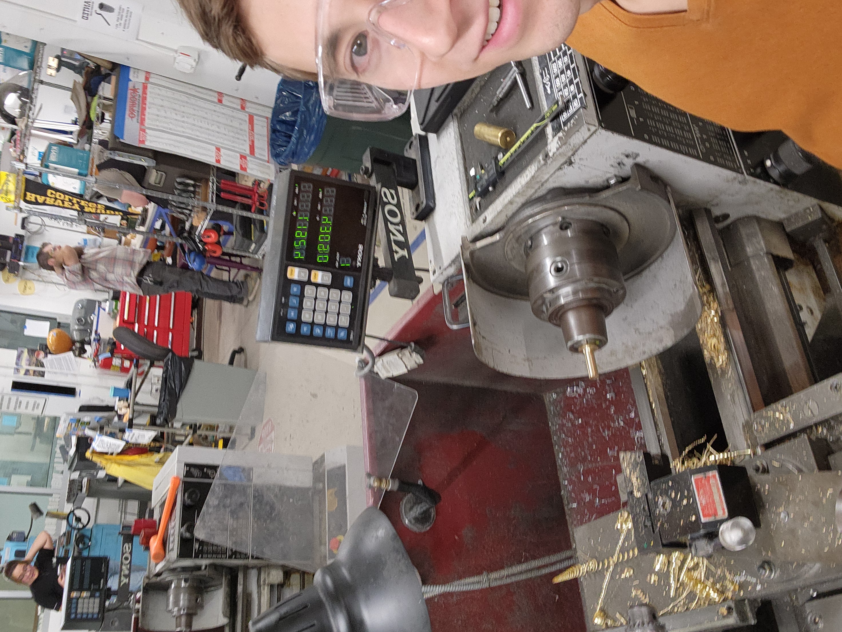 Selfie with brass fidget toy base on lathe.